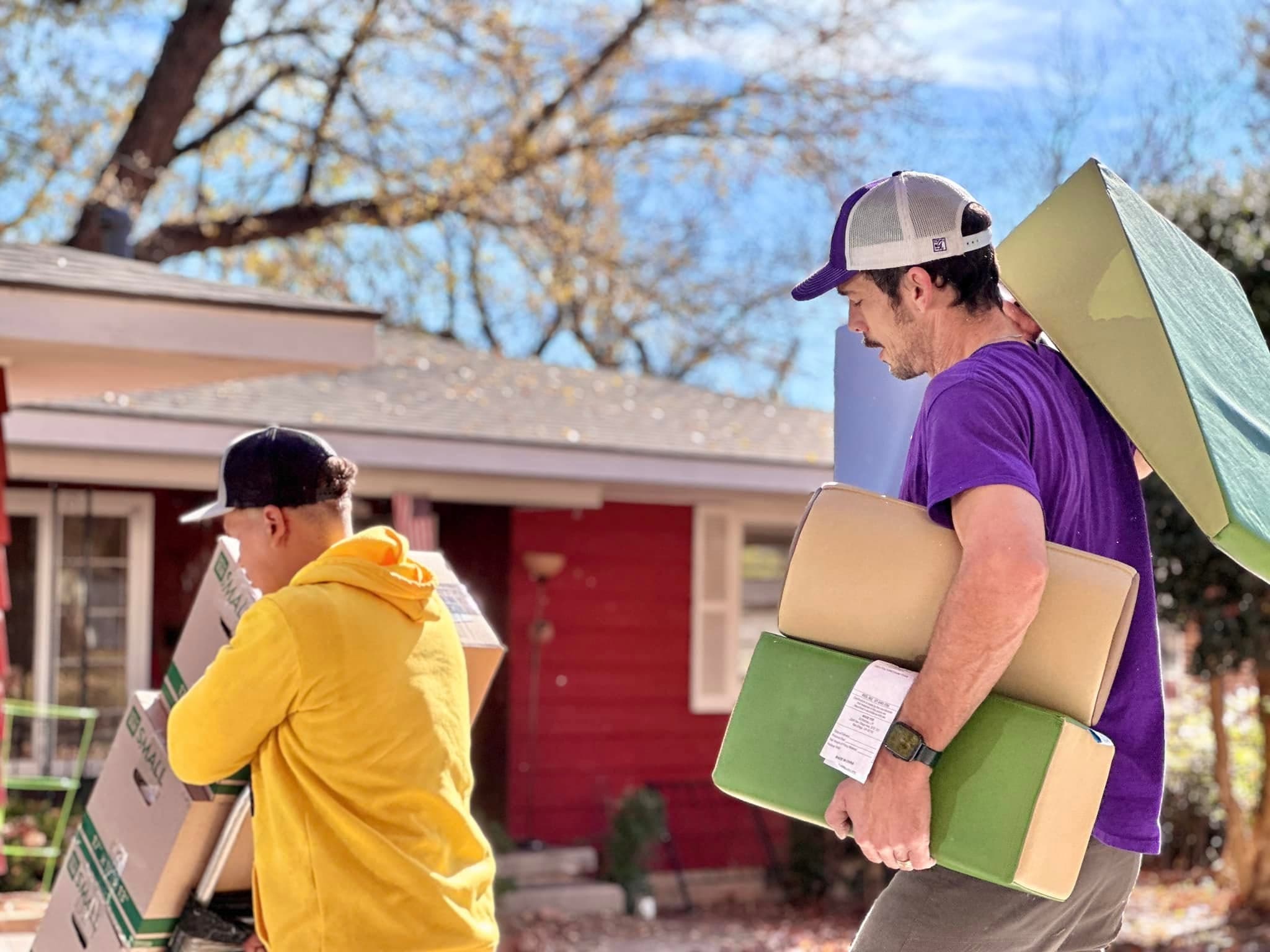 Jam'N Moving crew carrying furniture on a moving job